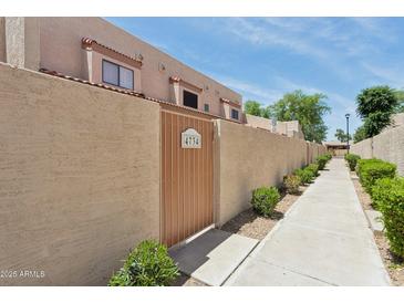 Exterior view of unit with private entrance, pathway, and tan stucco walls at 4734 W Golden Ln, Glendale, AZ 85302