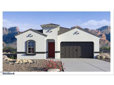 Charming single-story home featuring stucco siding, a dark garage door, and desert landscaping with mountain views at 7303 W Buckhorn Trl, Peoria, AZ 85383