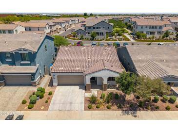 Aerial view of charming single-Gathering home featuring a tile roof and neat desert landscaping at 9921 E Acceleration Dr, Mesa, AZ 85212