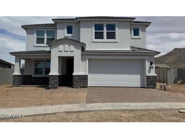 Charming two-story home features a covered entryway, a two-car garage, and neutral-toned stucco at 10043 S 23Rd Dr, Phoenix, AZ 85041