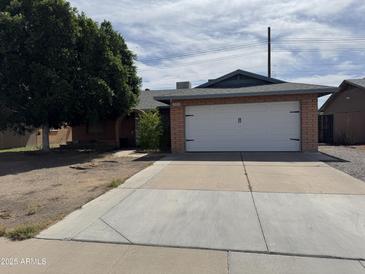 Charming single-story home featuring a two-car garage and a well-maintained front yard at 11221 N 91St Dr, Peoria, AZ 85345