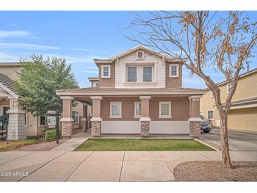 Charming two-story home with a covered porch and well-manicured lawn for curb appeal at 12022 W Belmont W Dr, Avondale, AZ 85323