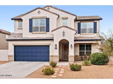 Beautiful two-story home showcasing a well-maintained front yard and a two-car garage at 18309 N Crestview Ln, Maricopa, AZ 85138