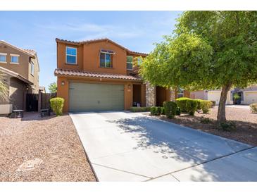 Charming two-story home with a well-manicured front yard and a two-car garage at 18649 W Williams St, Goodyear, AZ 85338
