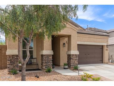 Charming single-Gathering home featuring desert landscaping, a two-car garage, and inviting covered entryway at 1951 W Plum Rd, Phoenix, AZ 85085