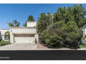 Inviting two-story home featuring a two-car garage and desert landscaping at 4226 N 69Th Pl, Scottsdale, AZ 85251