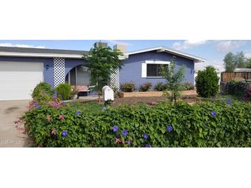 Charming blue home with a well-manicured, landscaped front yard and white lattice accents at 4626 W Altadena Ave, Glendale, AZ 85304
