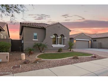 Charming single-story home showcasing a well-manicured lawn and paver driveway at 11957 W Daley Ln, Sun City, AZ 85373
