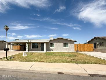 Charming single-story home with tidy landscaping, carport, and desert charm at 12230 N 47Th Dr, Glendale, AZ 85304