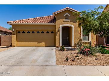 Inviting single-story home featuring a two-car garage and desert landscaping in front at 16954 W Mohave St, Goodyear, AZ 85338