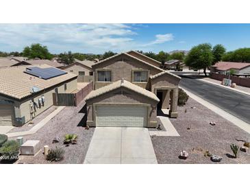 Charming two-story home featuring a neutral color palette, attached garage, and low maintenance desert landscaping at 1758 E San Xavier Dr, Casa Grande, AZ 85122