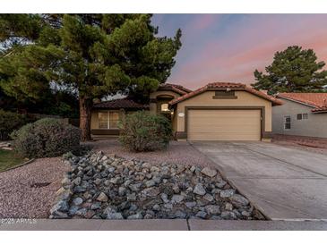 Charming single-story home with a desert landscape and a two-car garage at 19651 N 34Th St, Phoenix, AZ 85050