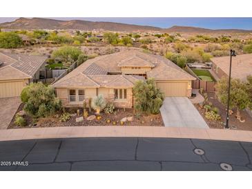 Beautiful single-story home with well manicured desert landscaping and three-car garage at 31705 N 128Th Dr, Peoria, AZ 85383