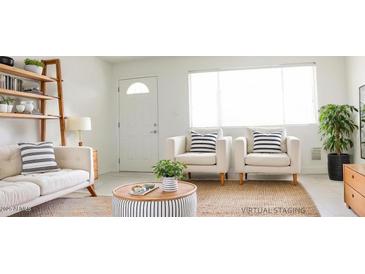 Bright living room featuring stylish furniture, decor, and natural light at 3556 W Augusta Ave, Phoenix, AZ 85051