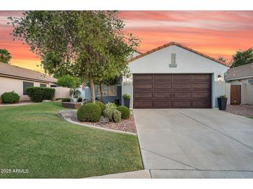 Charming single-Gathering home with mature trees, a well-manicured lawn, and a two-car garage at 5711 E Gable Ave, Mesa, AZ 85206