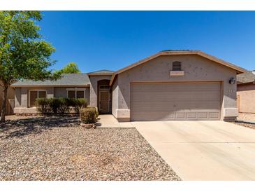 Charming single-story home features low-maintenance landscaping and attached two car garage at 1376 E Rosemary Trl, Casa Grande, AZ 85122