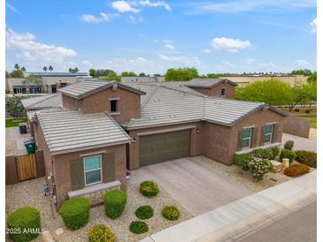 Stunning single-Gathering home featuring a three-car garage, meticulous landscaping and desert style plants at 14075 W Desert Flower Dr, Goodyear, AZ 85395