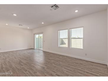 Spacious living room with wood-style floors, recessed lighting, and natural light at 1577 N Pueblo Dr, Apache Junction, AZ 85120