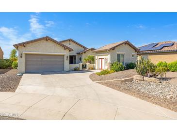 A lovely single-Gathering home featuring a well-manicured yard and a spacious two-car garage at 20082 N 272Nd Ln, Buckeye, AZ 85396