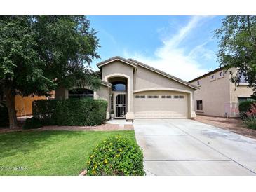 Charming single-story home with well-manicured lawn, mature landscaping, and inviting two-car garage at 2727 S 160 Ln, Goodyear, AZ 85338