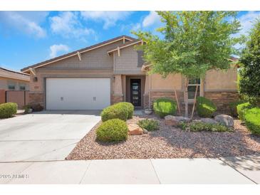Charming single-story home featuring well-kept landscaping and a two-car garage, enhancing its curb appeal at 4853 N 183Rd Ln, Goodyear, AZ 85395
