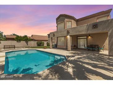 Inviting backyard with a sparkling pool, covered patio, and desert landscaping; perfect for outdoor living at 5212 S Monte Vista St, Chandler, AZ 85249