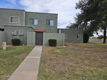 Inviting condo with drought-tolerant landscaping, private entrance, and attractive facade at 5446 W Sheena Dr, Glendale, AZ 85306