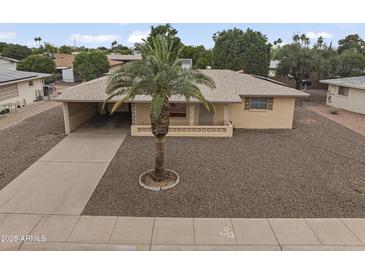 View of single-story home showcasing the well-maintained landscape, neutral tones, and convenient carport at 6217 E Dodge St, Mesa, AZ 85205