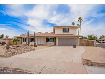 Inviting two-story home featuring a two-car garage and drought-tolerant landscaping at 9803 N 40Th Dr, Phoenix, AZ 85051