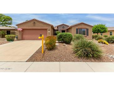 Charming single-story home with desert landscaping, a two-car garage and a 'Coming Soon' sign in the front yard at 19722 N Regents Park Dr, Surprise, AZ 85387
