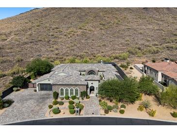 Stunning desert home with beautiful stonework, mature landscaping, and a charming paver driveway at 36133 N 24Th Ave, Phoenix, AZ 85086