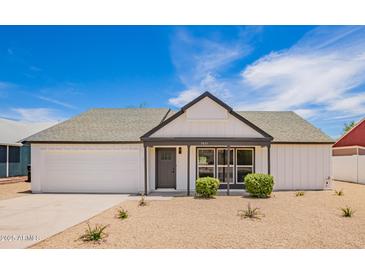 Charming single-story home with a well-manicured yard and appealing modern design at 9855 S 47Th Pl, Phoenix, AZ 85044