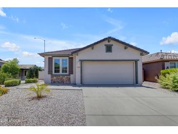 Charming single-story home with a two-car garage, desert landscaping and stone accents at 11159 E Sebring Ave, Mesa, AZ 85212