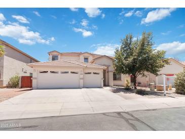 Spacious two-story home with a three car garage and a well-manicured front yard at 43525 W Cydnee Dr, Maricopa, AZ 85138