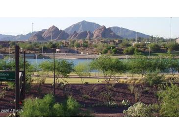 Scenic lake view with lush landscaping, mountain views, and walking path at 525 W Lakeside Dr # 151, Tempe, AZ 85281