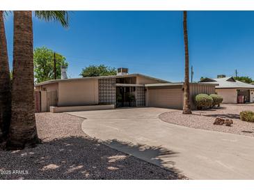Charming home featuring a circular driveway and desert landscaping at 5420 N Granite Reef Rd, Scottsdale, AZ 85250
