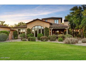 Charming home with a well-manicured lawn, mature landscaping, and a covered entryway at 7710 E Golden Eagle Cir, Gold Canyon, AZ 85118