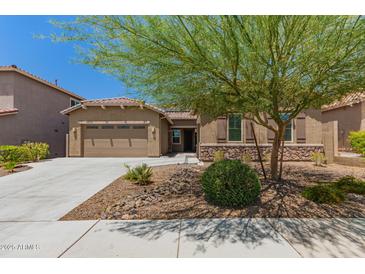 Charming single-story home with a two-car garage, desert landscaping, and a stone accent wall at 10502 W Bronco Trl, Peoria, AZ 85383