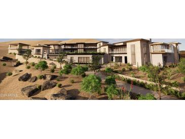 Stunning modern home with a desert landscape, stone accents, multiple balconies, and large windows at 10772 E Canyon Cross Way, Scottsdale, AZ 85255