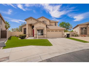 Charming two-story home featuring a red front door, desert landscaping, and a spacious two-car garage at 2602 E Glass Ln, Phoenix, AZ 85042