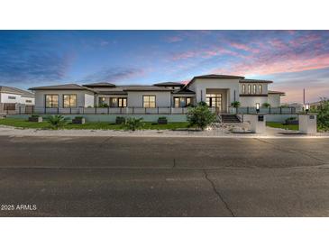 Striking modern home with clean lines, a manicured front yard, and a multi-level roofline against a vibrant sky at 3653 E Runaway Bay Pl, Queen Creek, AZ 85142