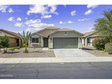 Charming single-story home with a two-car garage, desert landscaping, and tile roof under a bright sky at 41839 W Avella Dr, Maricopa, AZ 85138