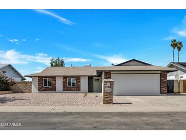 Charming single-story home featuring a neutral color palette, brick accents, and a well-maintained yard at 4720 W Northview Ave, Glendale, AZ 85301