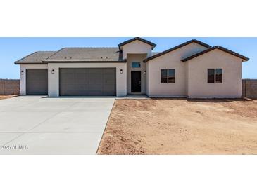 Charming single-story home featuring a spacious three-car garage and a low-maintenance desert landscape at 9429 W Sandstone Mountain Dr, Casa Grande, AZ 85194