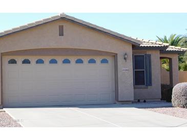 Exterior view of a two-car garage with decorative windows and a well-maintained driveway at 20282 N 104Th Ave, Peoria, AZ 85382
