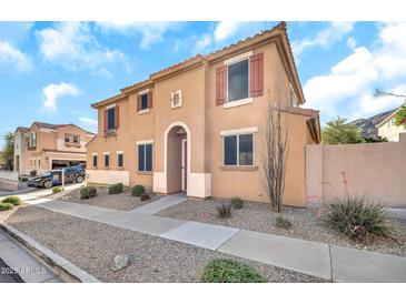 Inviting two-story home featuring a stucco exterior, tiled roof, and desert landscaping at 450 W Mountain Sage Dr, Phoenix, AZ 85045