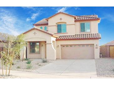 Charming two-story home features a tile roof, desert landscaping, and a two-car garage at 15241 W Madison St, Goodyear, AZ 85338