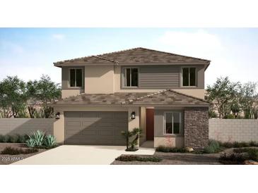 Charming two-story home featuring a stone facade, attached garage, and well-manicured landscaping in a suburban setting at 18186 W Larkspur Dr, Goodyear, AZ 85338