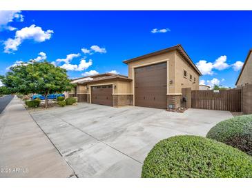 Spacious three-car garage with a large driveway, offering ample parking and convenient access at 18495 W Rimrock St, Surprise, AZ 85388