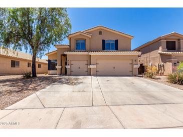 Two-story home with a large concrete driveway and a three-car garage at 4702 N 124Th Ave, Avondale, AZ 85392
